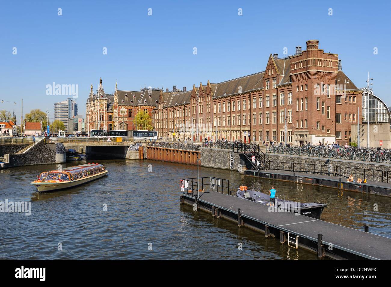 Sightseeng at Canal Boats near the Central Station of Amsterdam Stock Photo