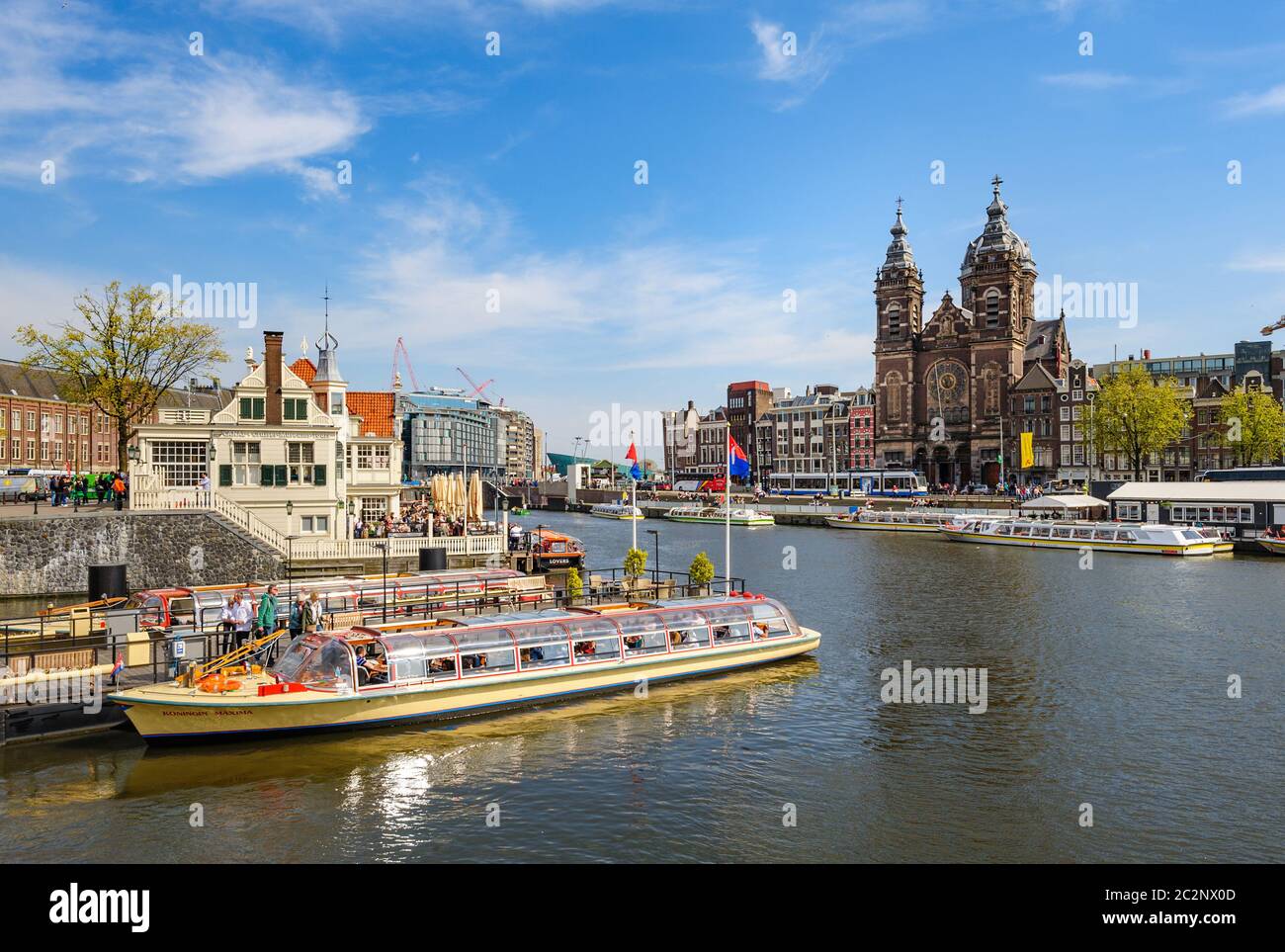 Sightseeng at Canal Boats near the Central Station of Amsterdam Stock Photo