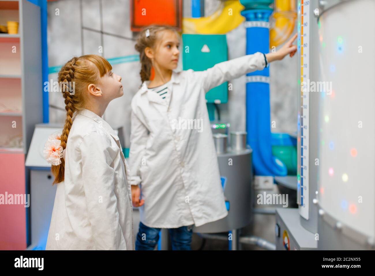 Little children in uniform playing doctors in laboratory, playroom. Kid ...