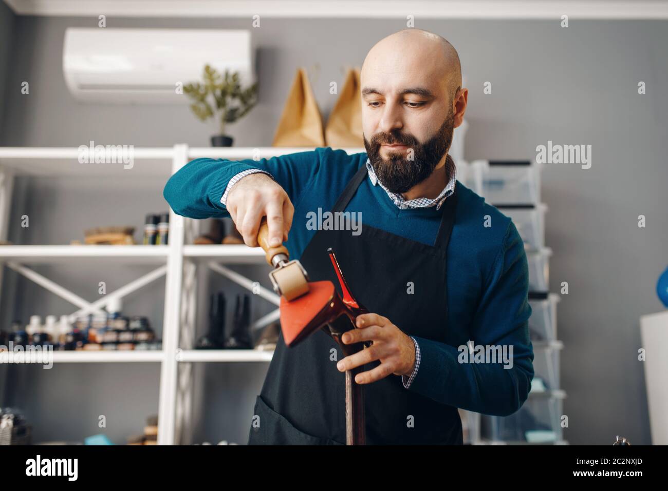 Shoemaker repairing the shoe, footwear repair service. Craftsman skill
