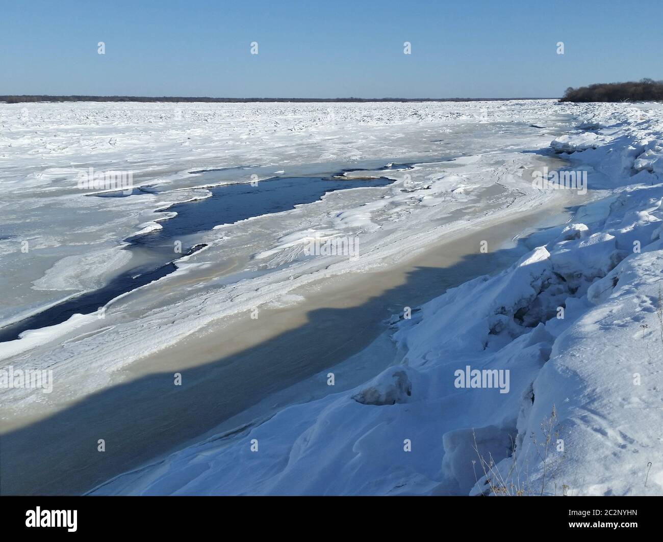 Anomalously cold spring. River is covered with ice Stock Photo