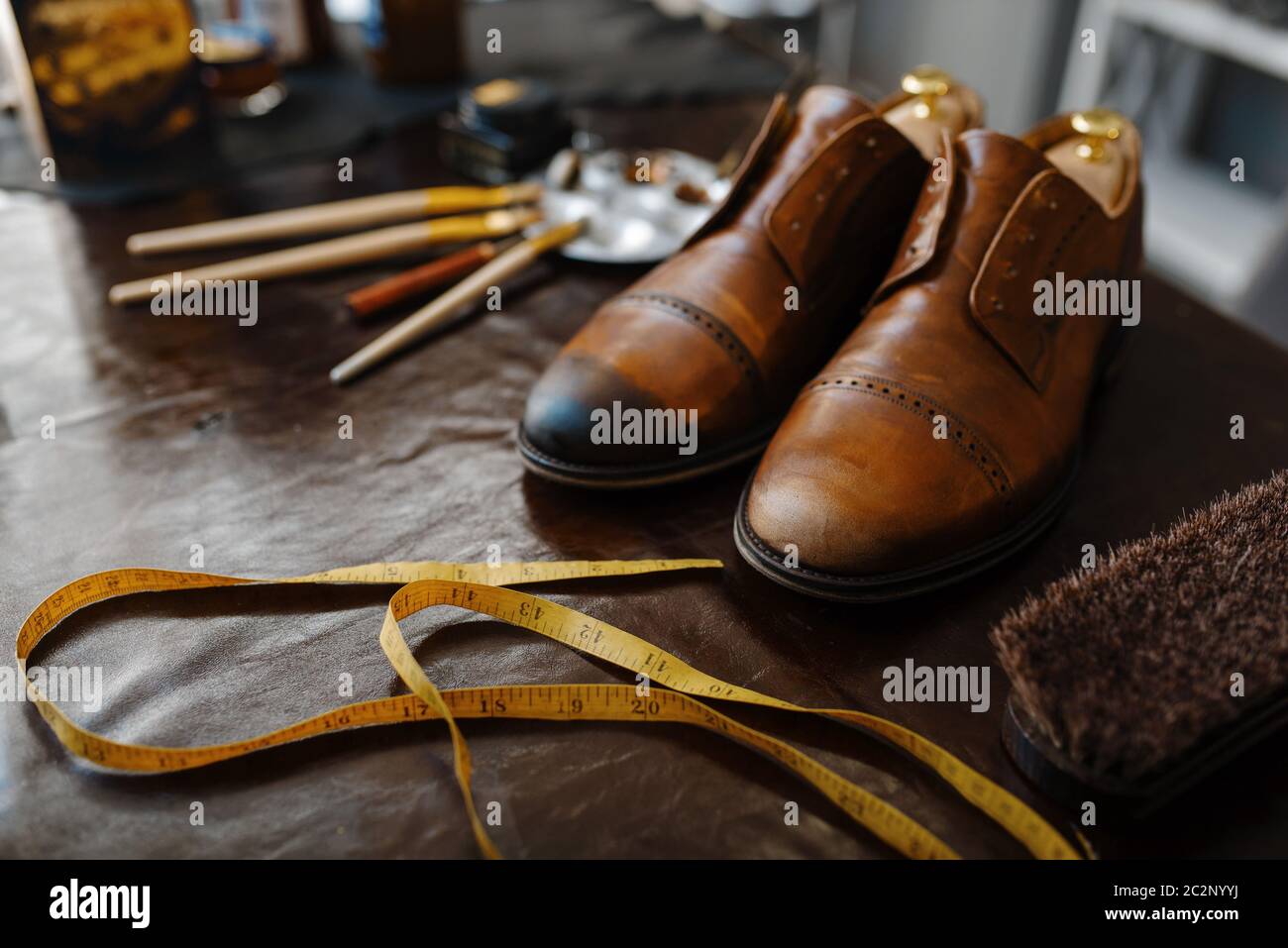 Shoemaker job, footwear repair service concept. Shoemaking