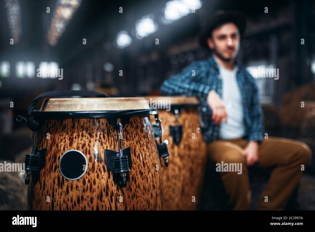 African wooden drums, closeup, male drummer on background. Djembe