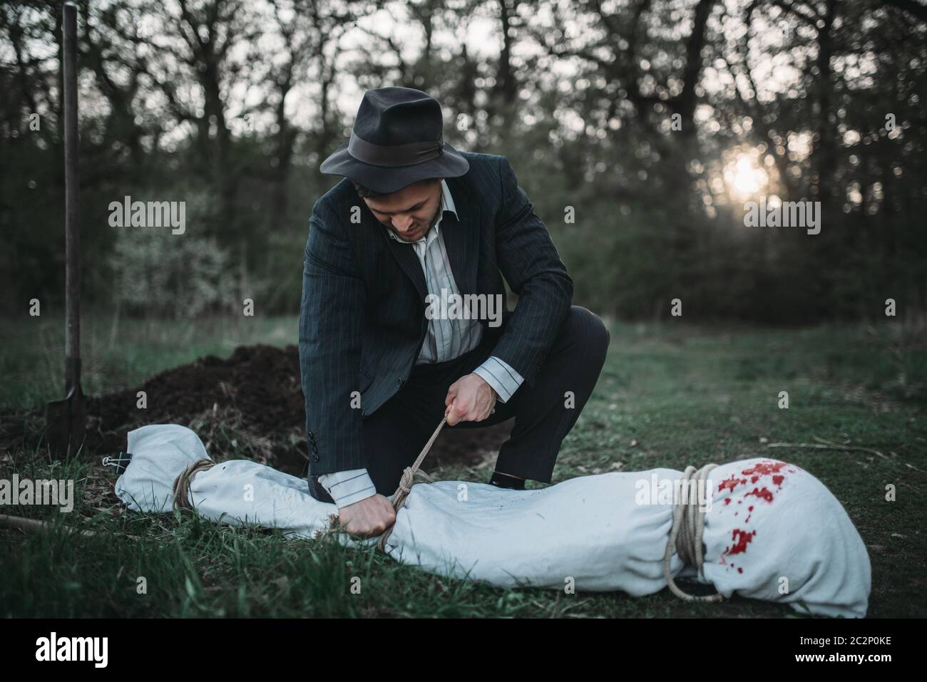 Bloody murderer digging grave victim hi-res stock photography and ...