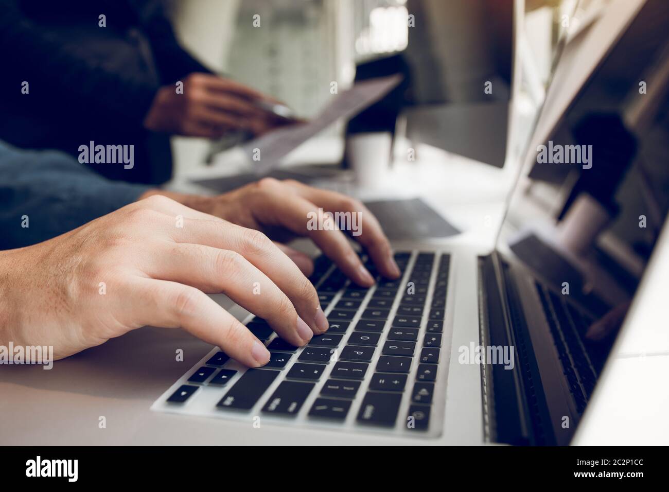 Two partnerships developing programming and coding technologies working on laptop and analyzing together. Stock Photo