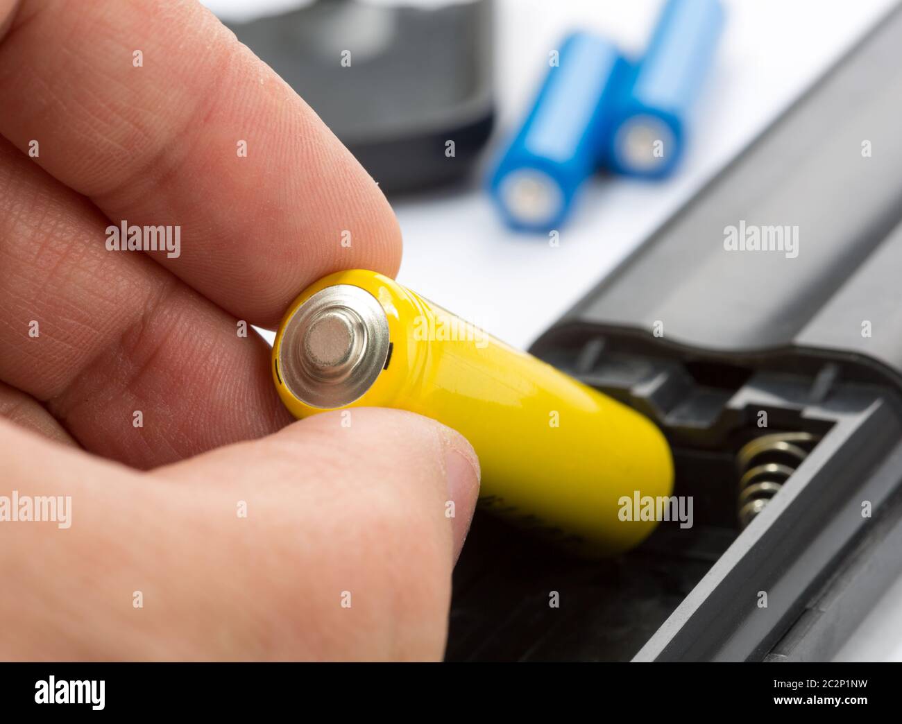 Loading batteries into a remote control Stock Photo Alamy