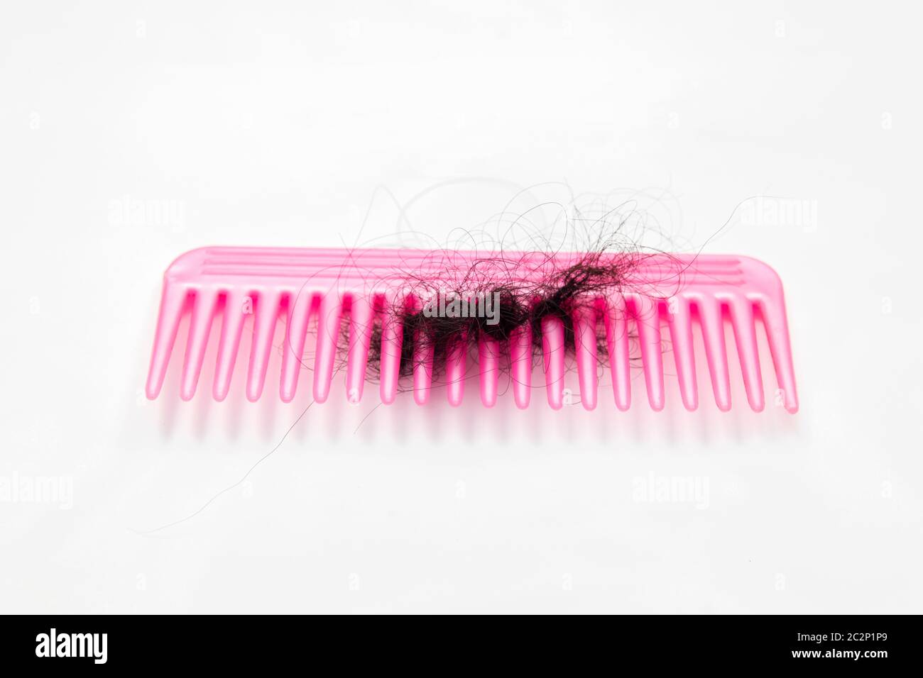 fallen hair stuck into comb Stock Photo Alamy