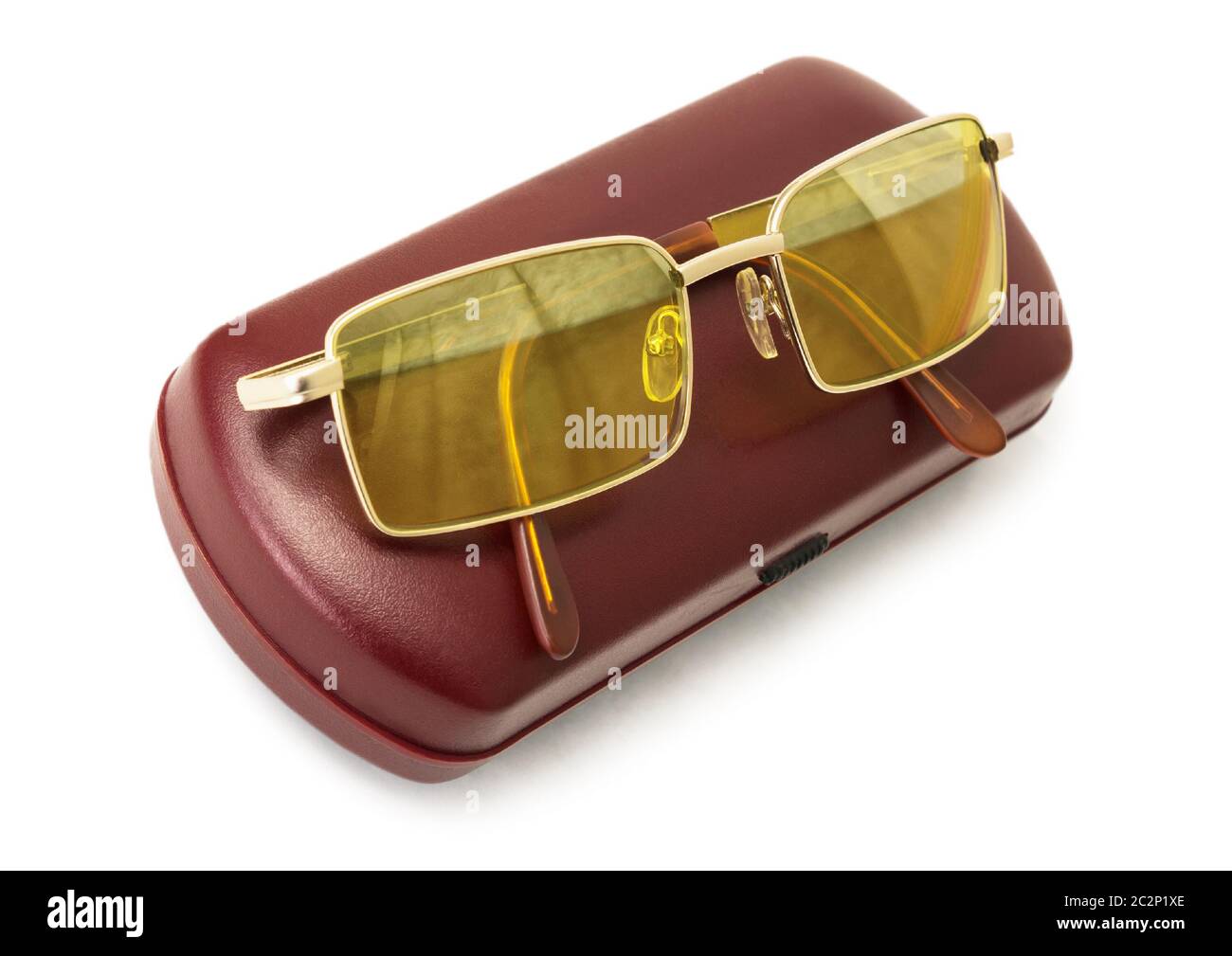 Anti-glare yellow driver's glasses on the  red case Stock Photo