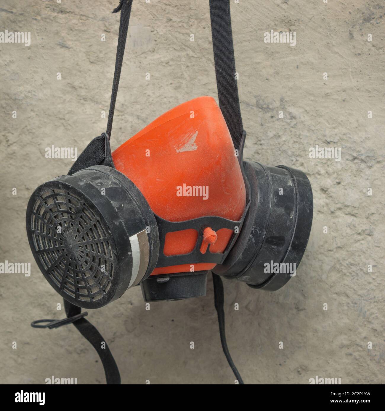 Used respirator hanging on the wall Stock Photo