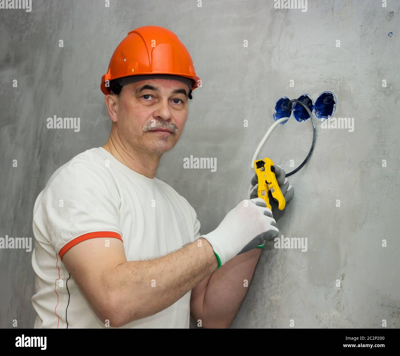 Electrician busy repairing wiring in apartment Stock Photo