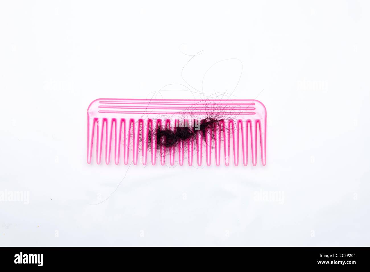 fallen hair stuck into comb Stock Photo