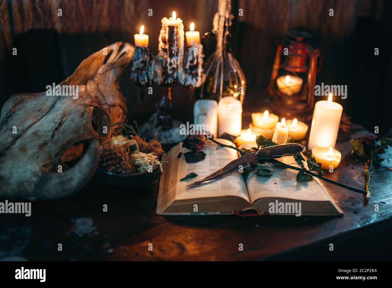 Witchcraft, dark magic, candles with ritual book on the table, nobody.  Occult and esoteric symbols Stock Photo - Alamy