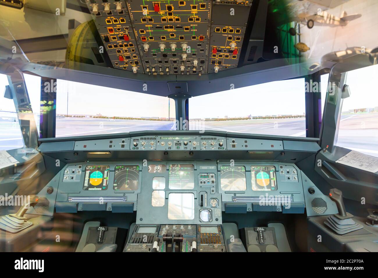 Inside airplane pilot cabin. Avionics dashboard, steering wheels