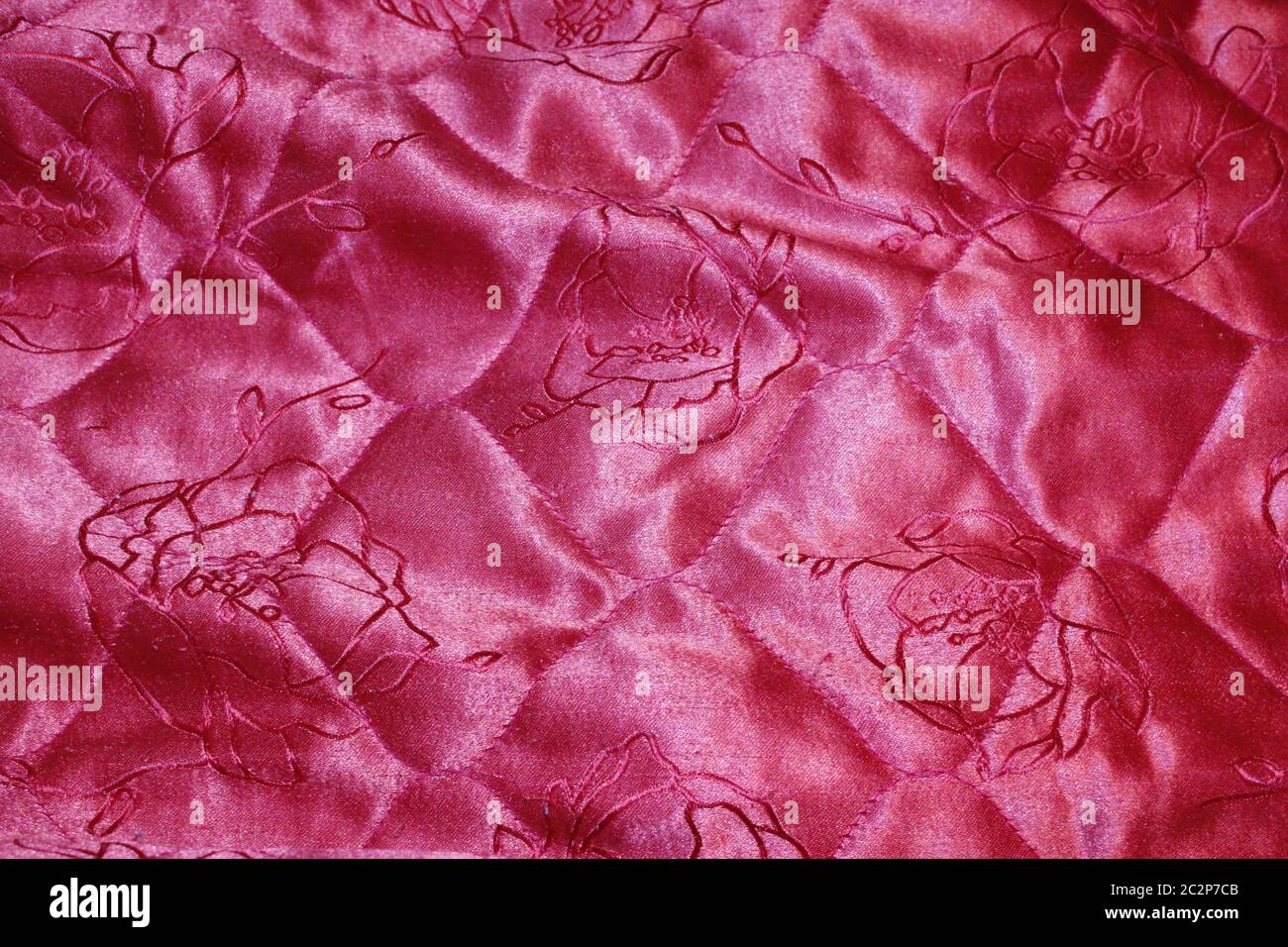 Texture on red coverlet with a pattern. Fabric texture. Red cloth background Stock Photo