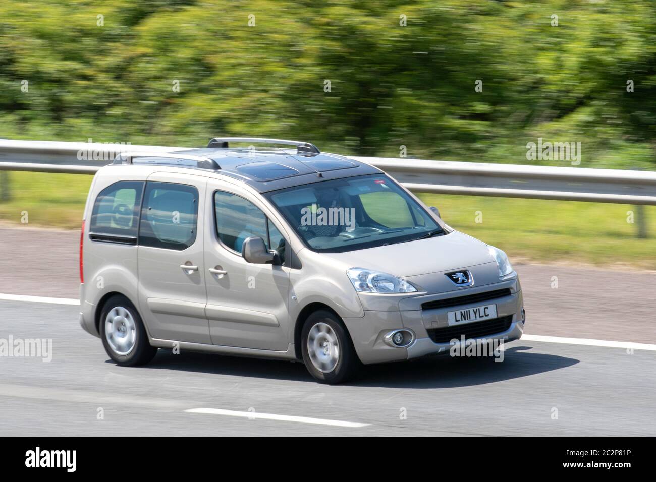 2011 beige Peugeot Partner Tepee Z-Ith Hdi75; Vehicular traffic moving vehicles, cars driving vehicle on UK roads, motors, motoring on the M6 motorway Stock Photo