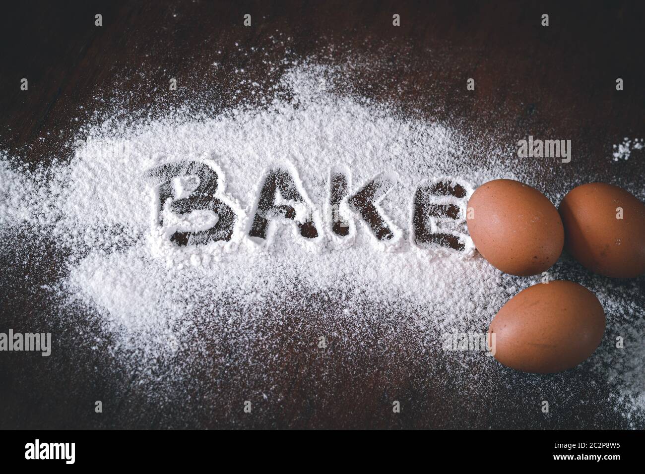 Conceptual still life photo of eggs and flour spilled on a table to show concept of baking as a way to support mental health and coping during home qu Stock Photo