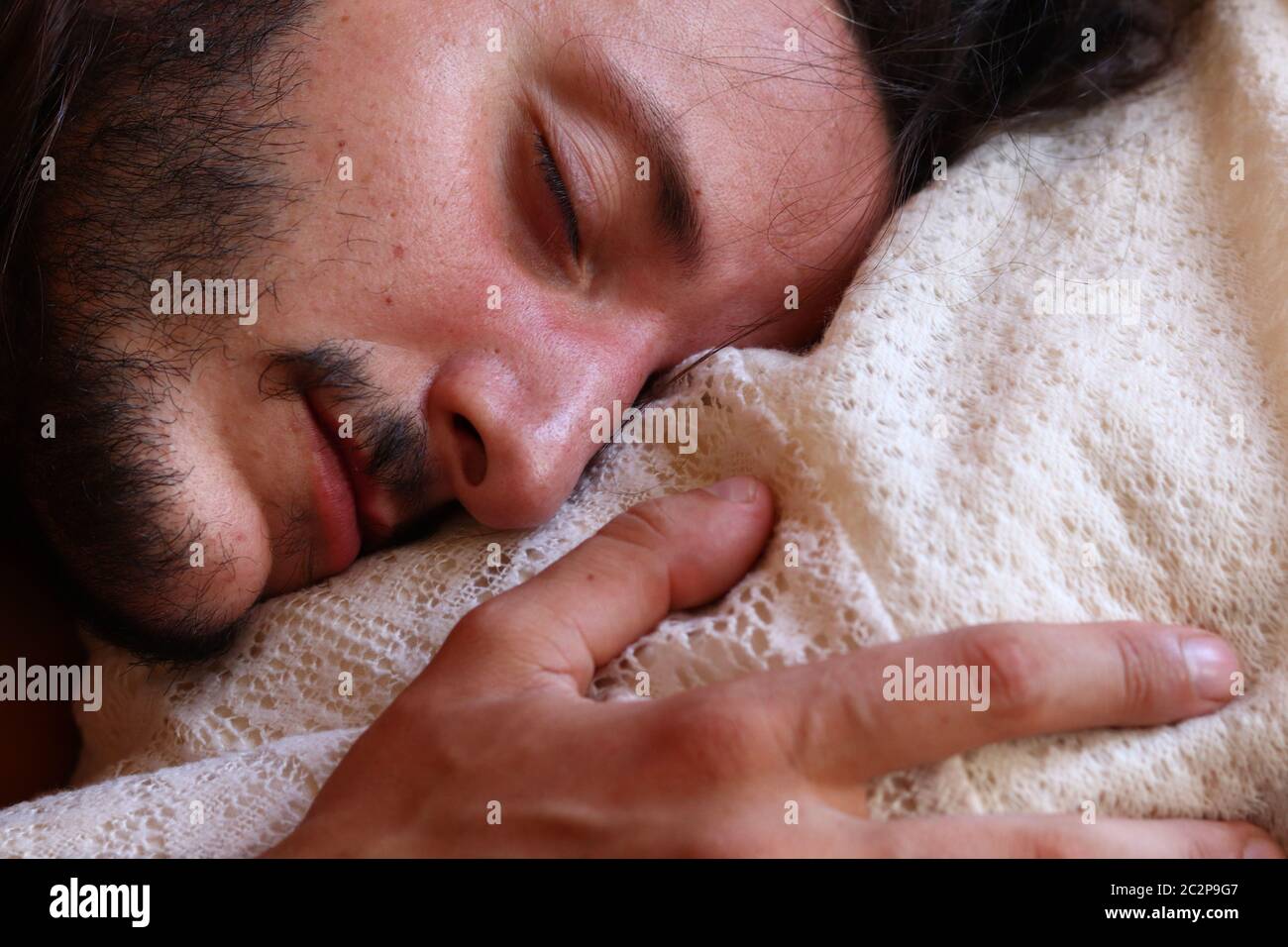 Caucasian man peacefully sleeping showing concept of coping with home quarantine and lock down during the covid-19 pandemic Stock Photo