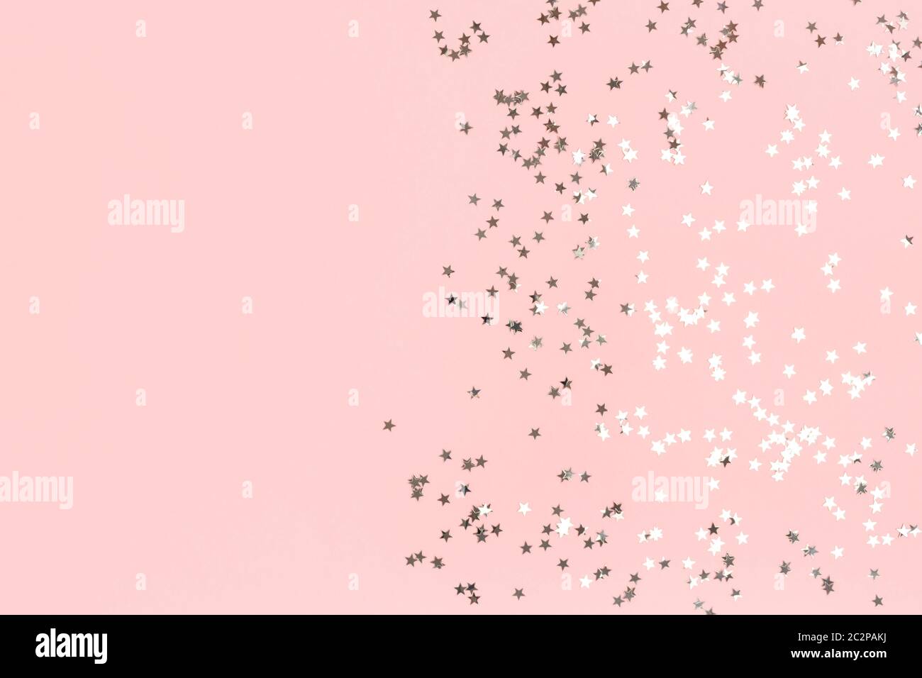 Silver shiny stars confetti on a pink pastel background. Festive frame ...
