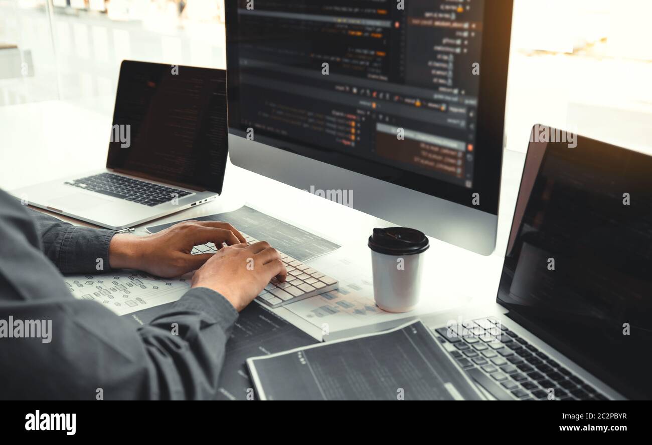 Asian man working code program developer computer web development working design software on desk in office. Stock Photo