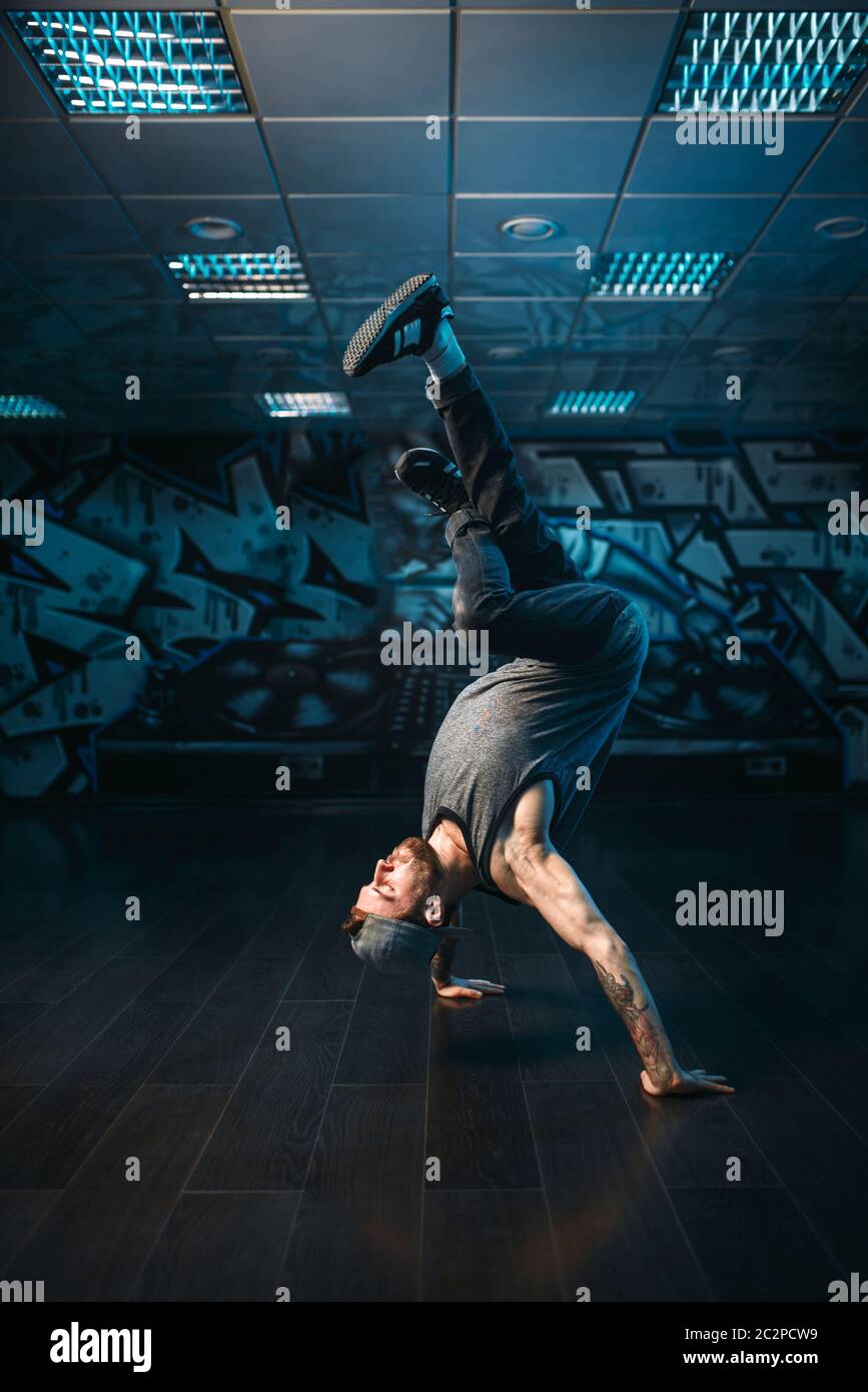 Hip hop motions, male performer in dance studio. Modern urban dancing