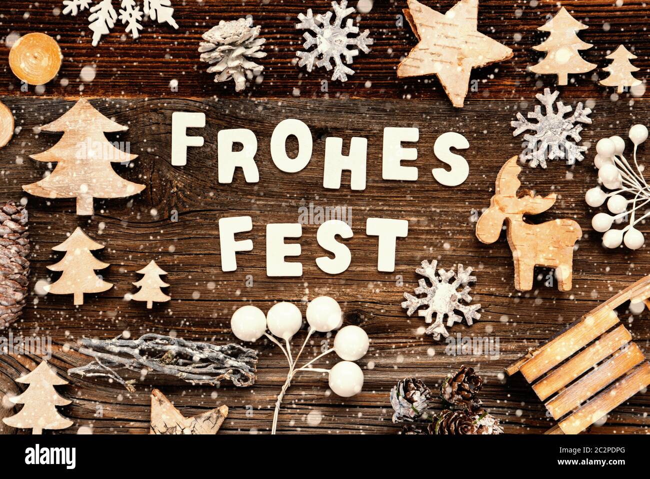 Letters Building The Word Frohes Fest Means Merry Christmas. Wooden Christmas Decoration Like Tree, Sled And Star. Brown Wooden Background With Snowfl Stock Photo