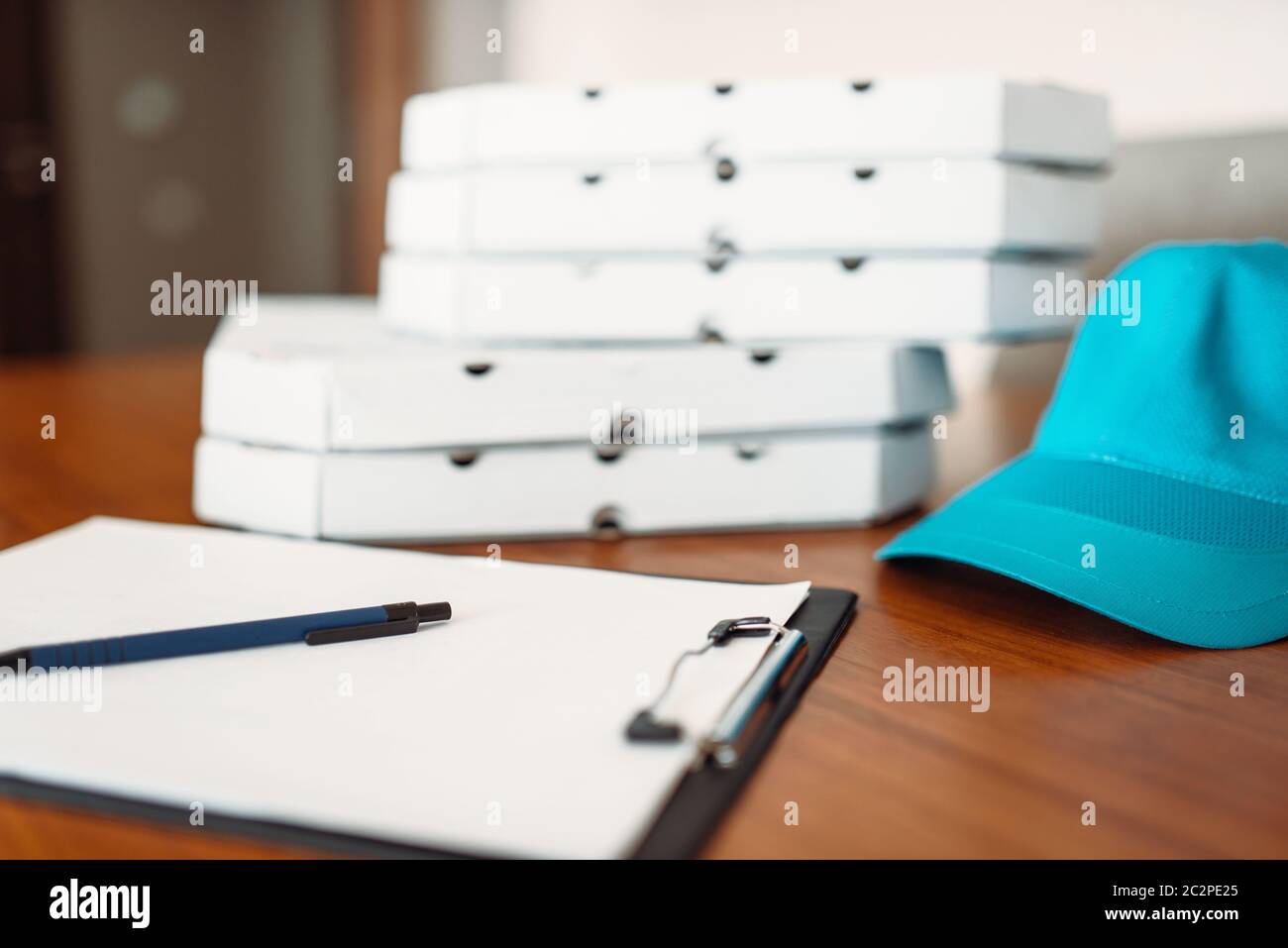 Carton pizza boxes, cap and empty order on table, top view. Pizza delivery business concept, fast delivering service Stock Photo