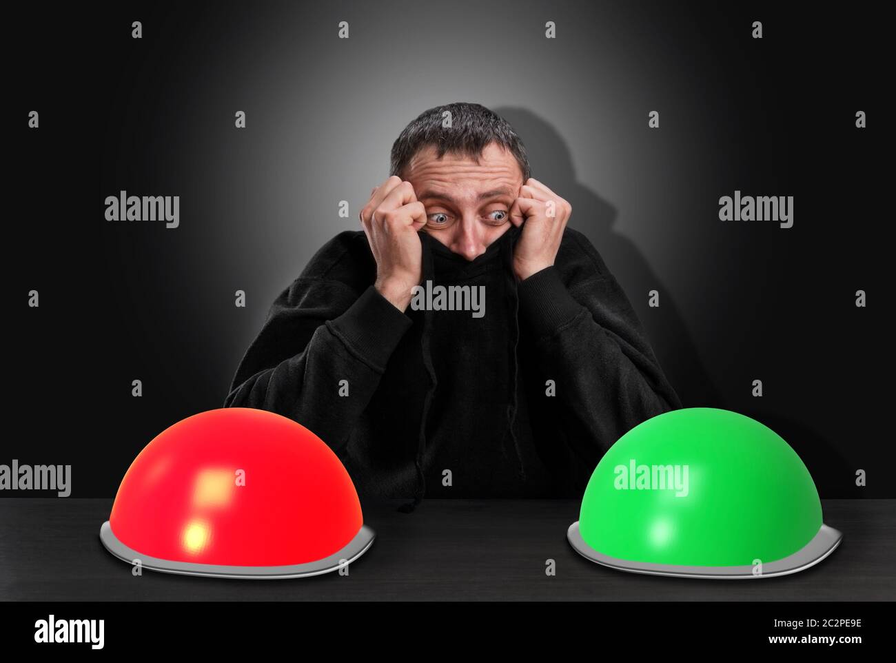 Thinking scared man chooses right button over grey Stock Photo - Alamy