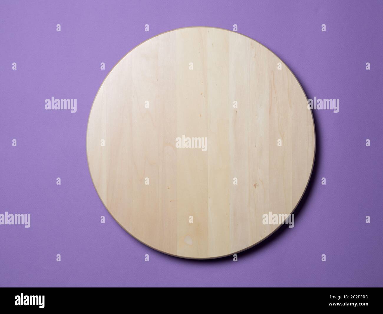 Empty wooden round tray on lilac background Stock Photo