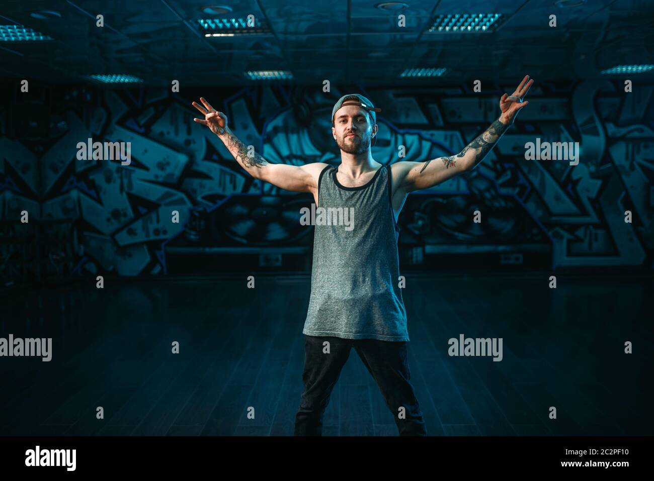 Male rapper in dance studio, trendy lifestyle. Modern urban dancing ...