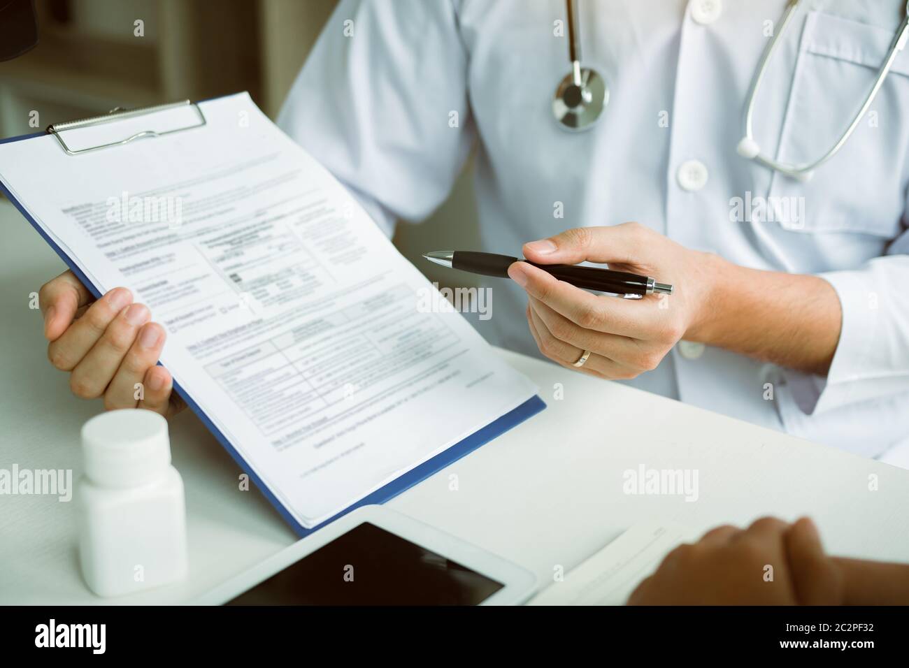 Doctor Is Writing The Appointment Letter To The Patient At The Clinic Stock Photo Alamy