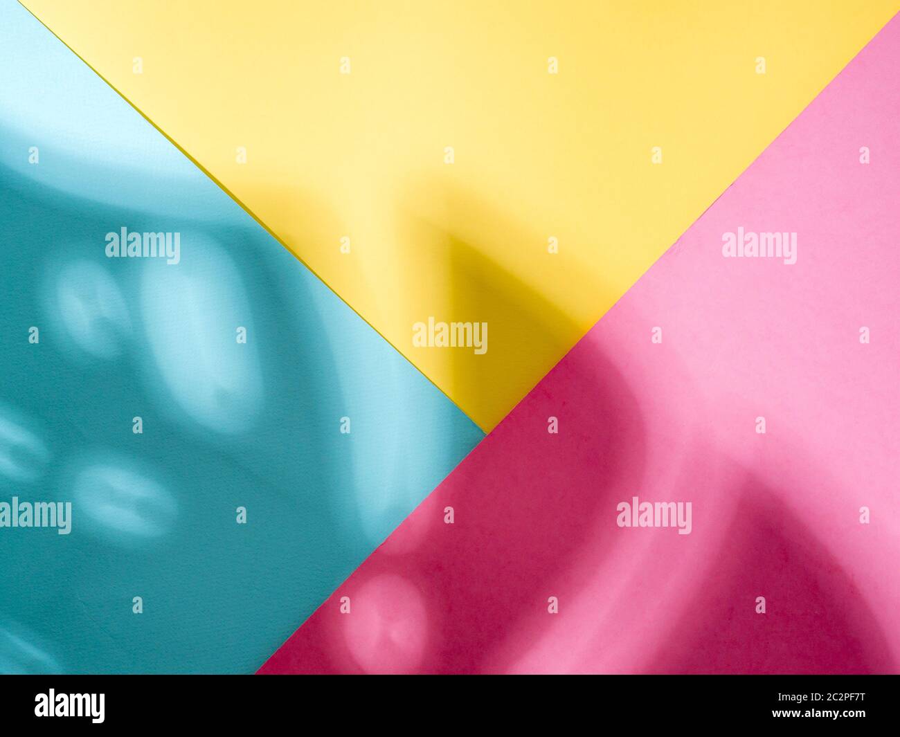 Monstera leaf shadow on colorful background Stock Photo