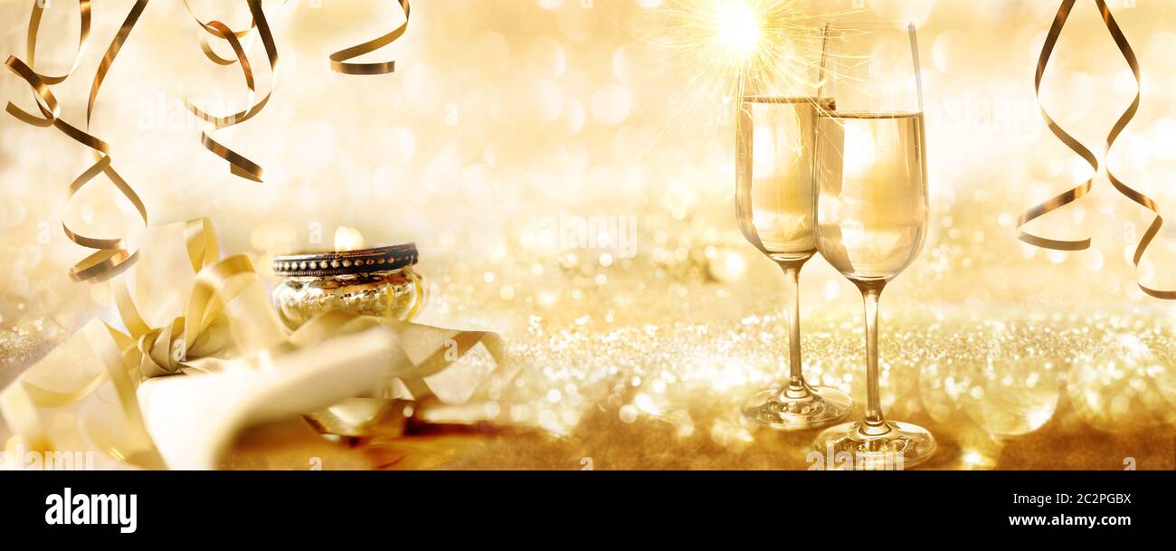 Golden sparkling new year and christmas background with champagne and candlelight for a concept Stock Photo