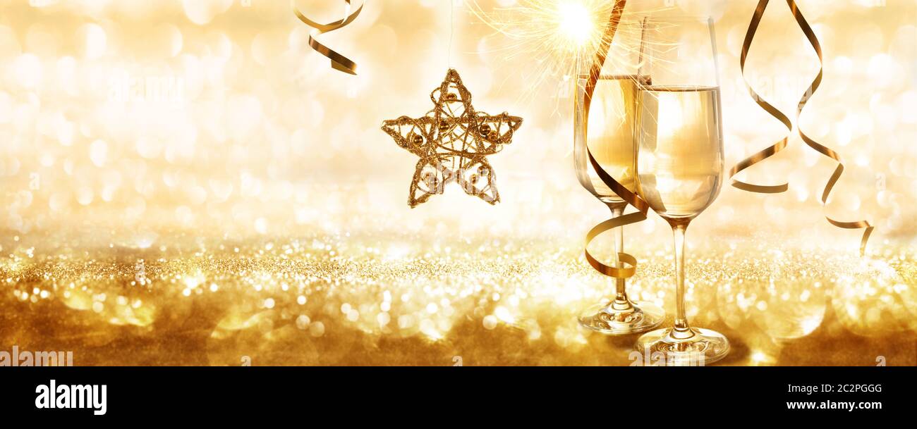 Golden sparkling new year and christmas background with champagne and a christmas star for a concept Stock Photo