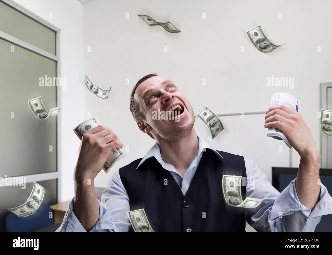 Happy businessman holds money and dreams in the office Stock Photo - Alamy