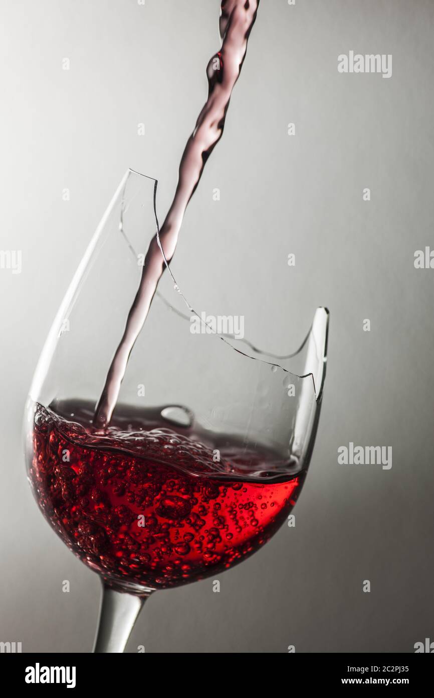 Filling a demaged wine glass Stock Photo