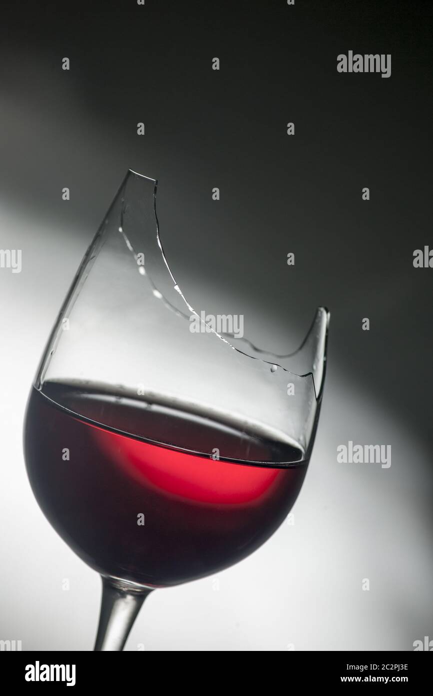 Upper part of broken red wine glass Stock Photo