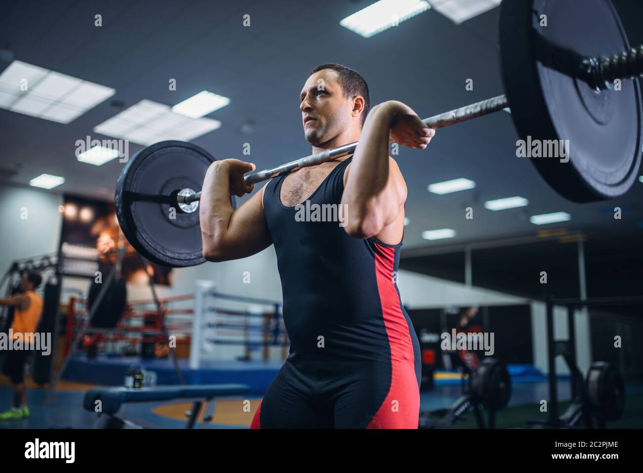Strong male powerlifter doing deadlift a barbell in gym. Weightlifting