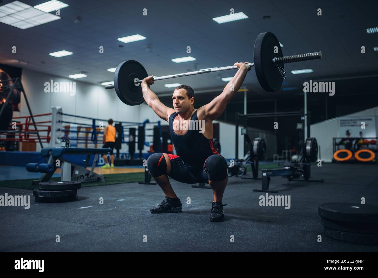 Strong male powerlifter doing deadlift a barbell in gym. Weightlifting