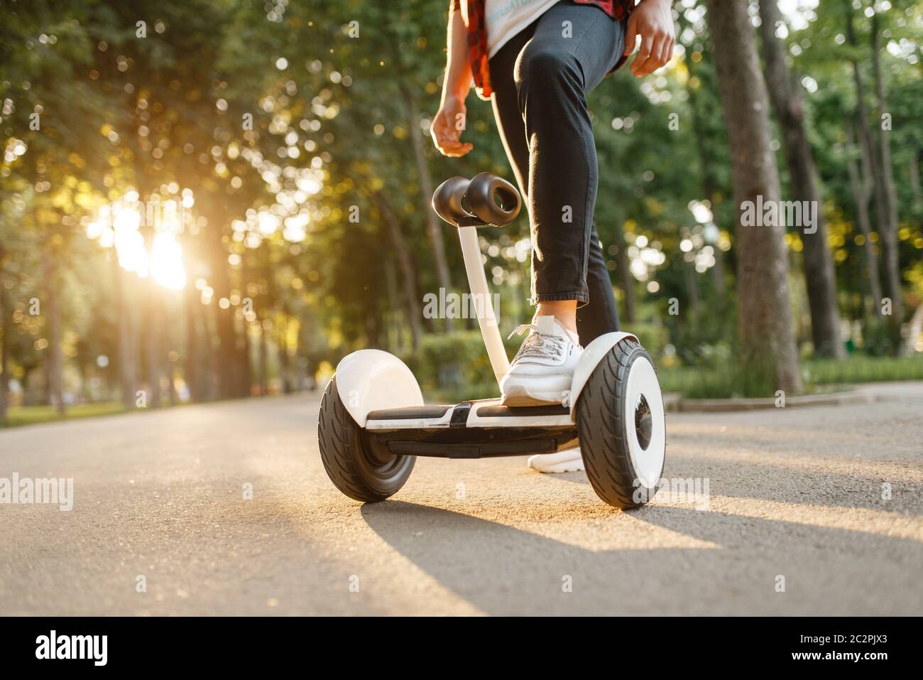 Young male person riding on gyroboard in summer park. Outdoor recreation  with electric gyro board. Eco transport with balance technology. Electrical  g Stock Photo - Alamy