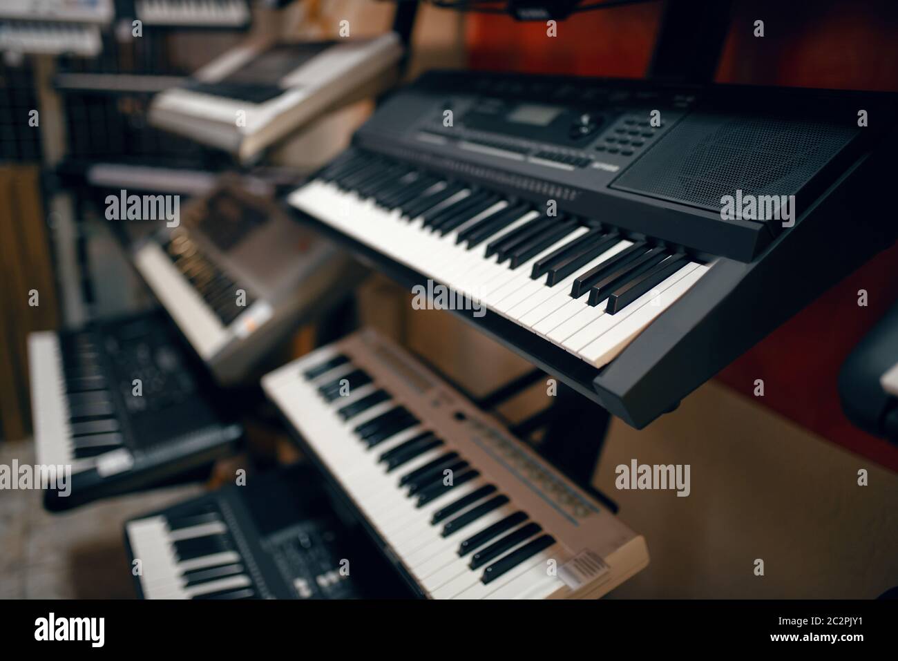 Digital synthesizers on showcase in music store, closeup view, nobody. Assortment in musical instrument shop, professional equipment for musicians and Stock Photo