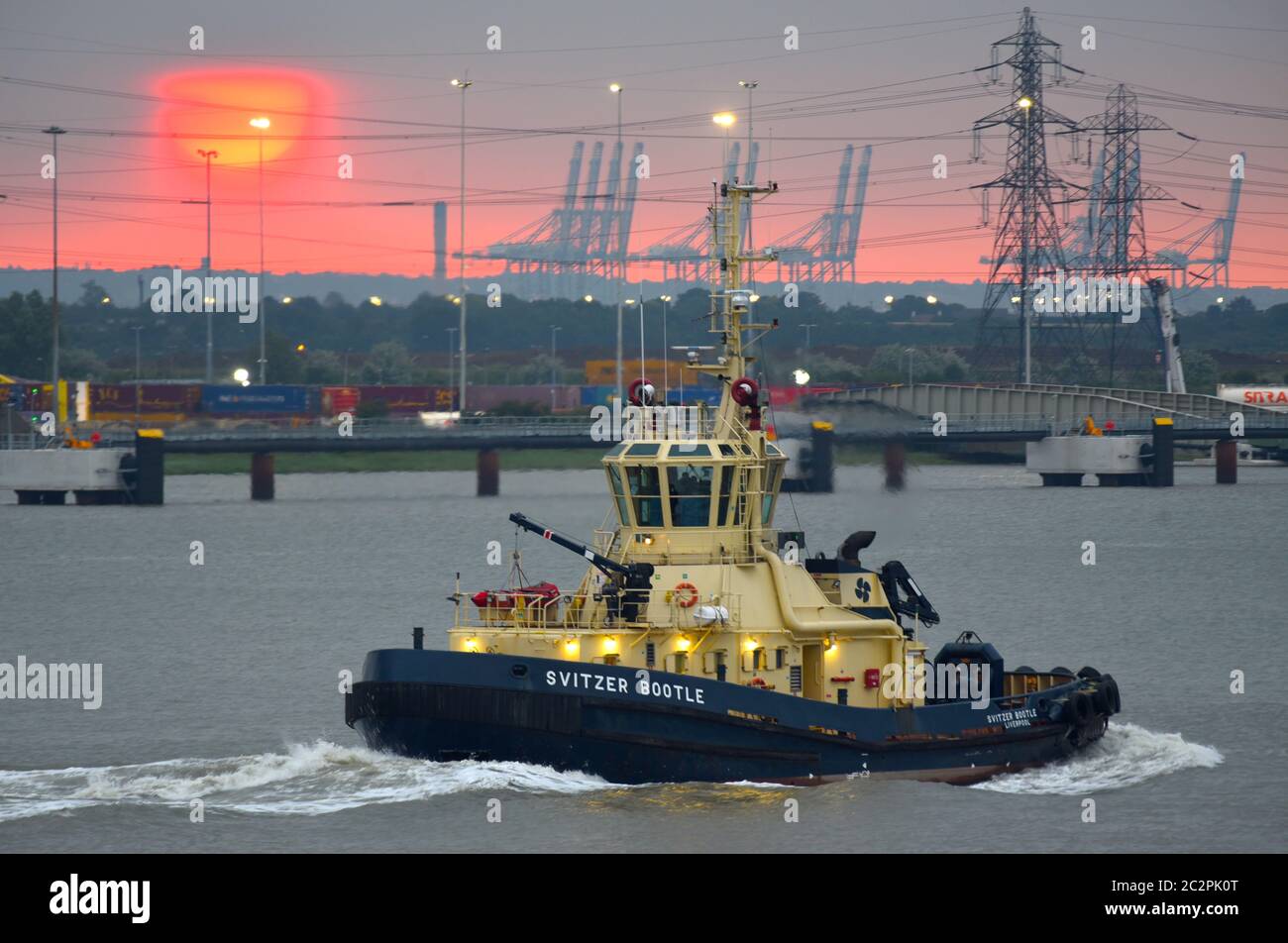 Tug Svitzer Bootle on the Thames with the sun rising over London Gateway. Stock Photo