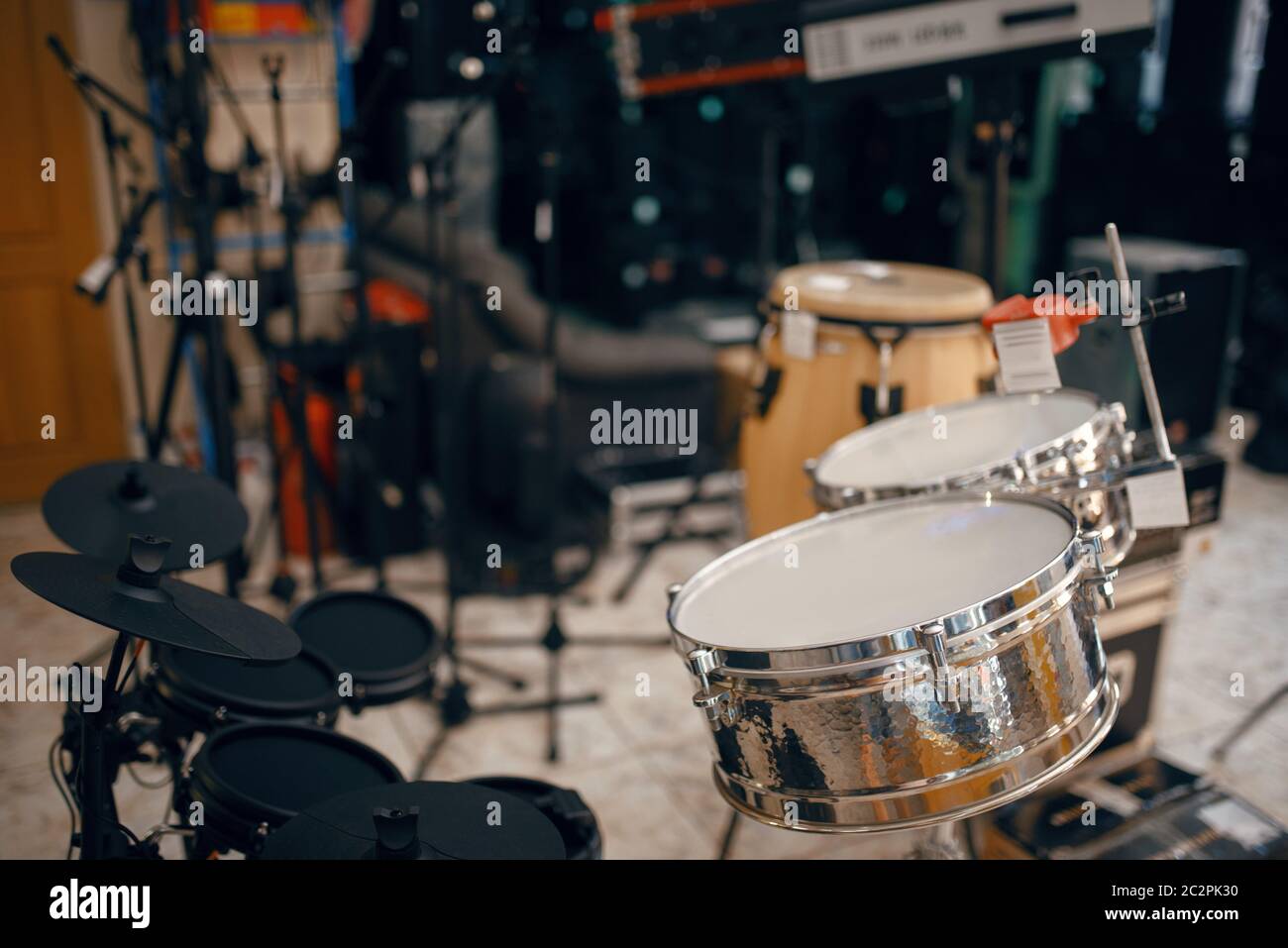 Drum set on showcase in music store, closeup view, nobody. Assortment