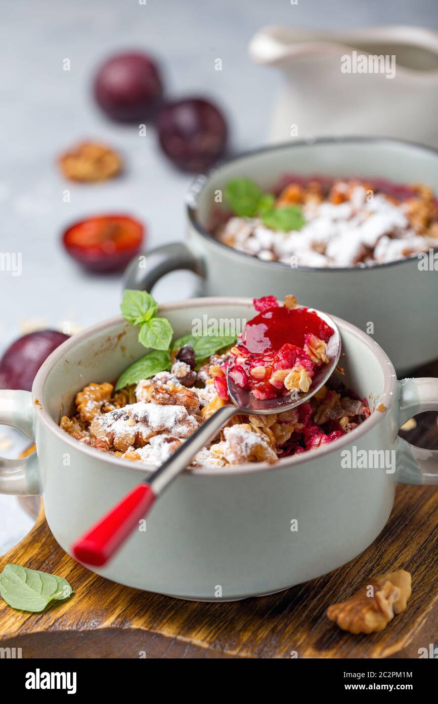 Delicious crumble of red cherry plum and oatmeal. Stock Photo