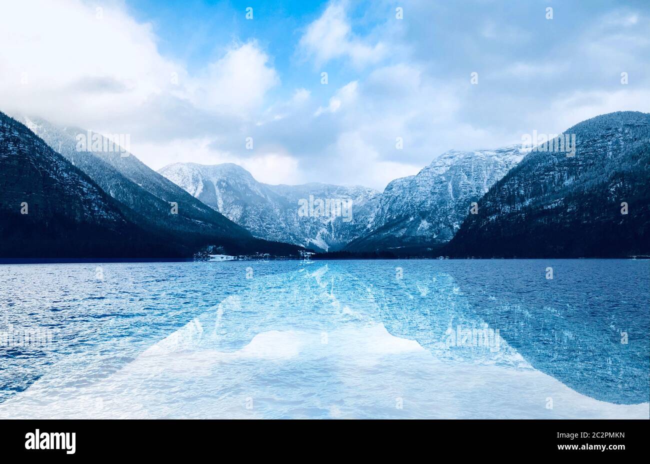 Panorama of Hallstatt lake outdoor with snow mountains with reflection in the water in Austria in Austrian alps Stock Photo