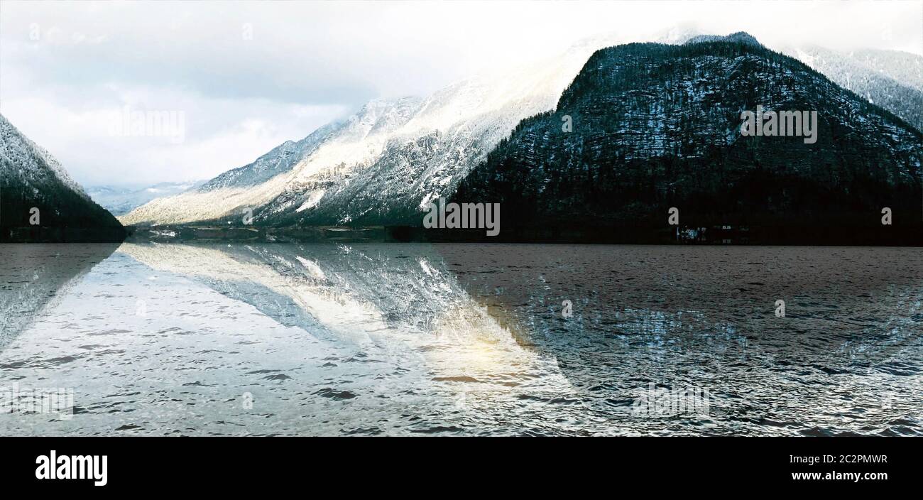 Panorama of Hallstatt lake outdoor with snow mountains with reflection in the water in Austria in Austrian alps Stock Photo