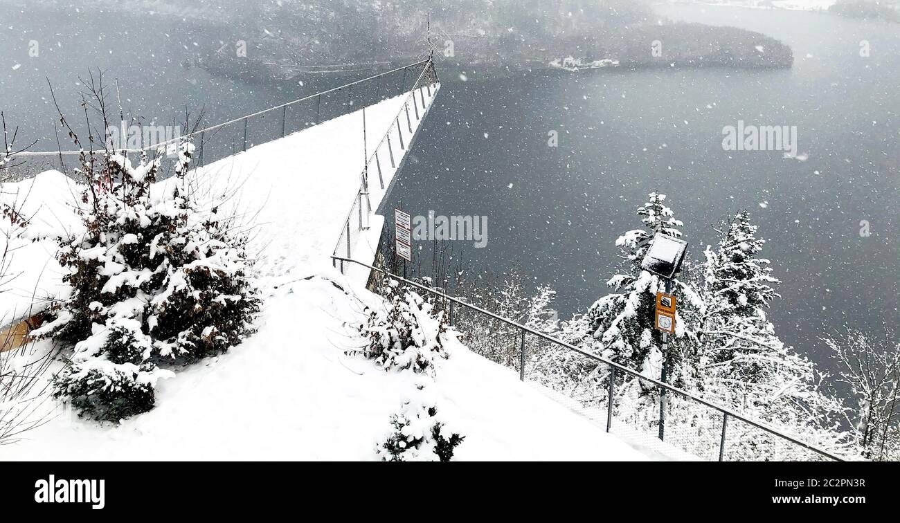 Triangle viewpoint of Hallstatt Winter snow mountain landscape hike epic mountains outdoor adventure and lake through the pine forest in upland valley Stock Photo