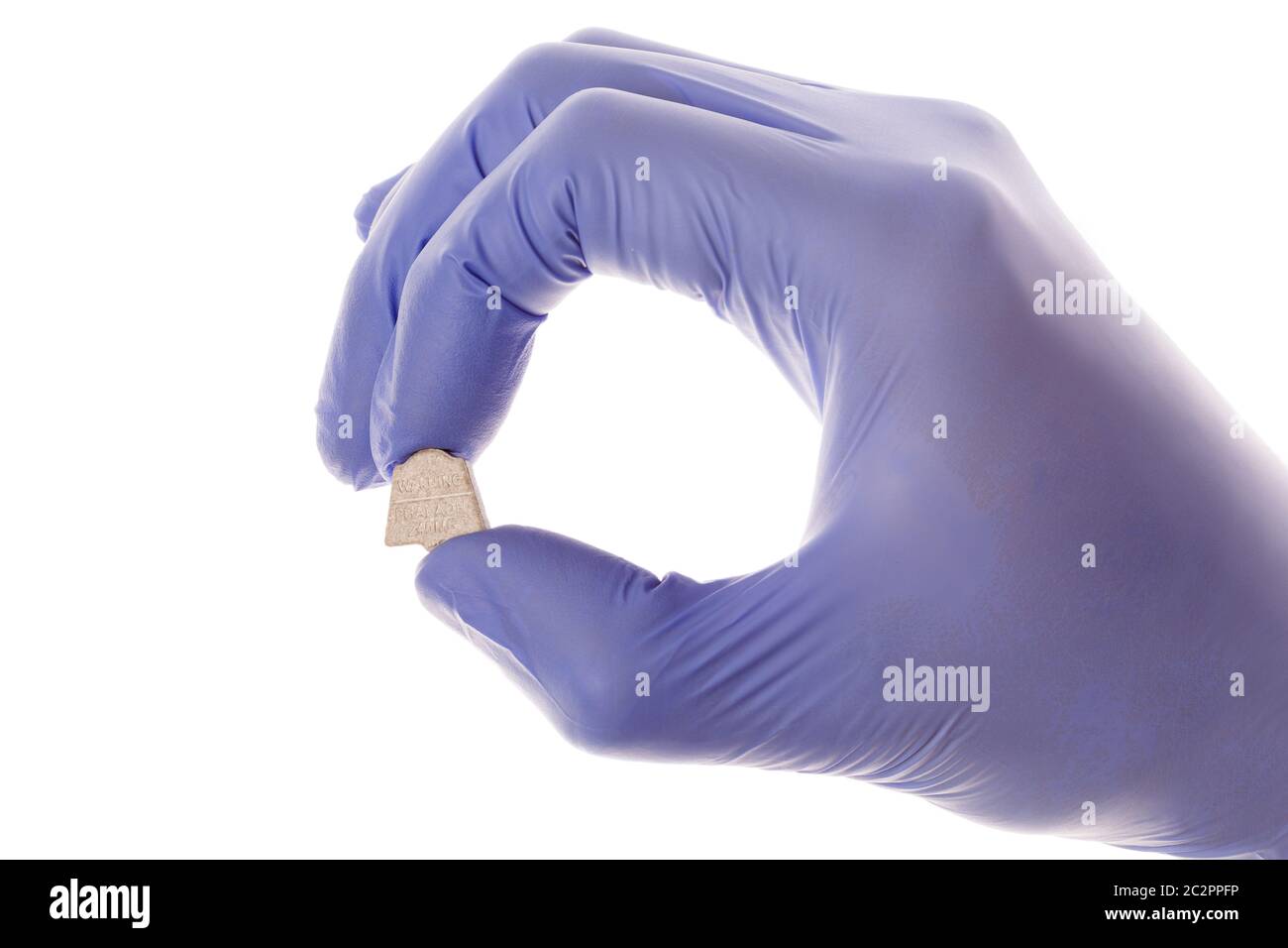 Ecstasy in doctor's hand. Clinical research, mdma assisted psychotherapy. Stock Photo