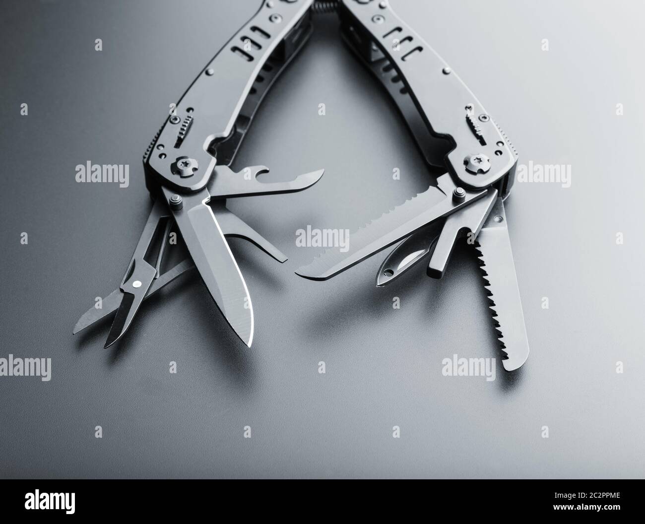 Black opened multitool knife with various tools Stock Photo