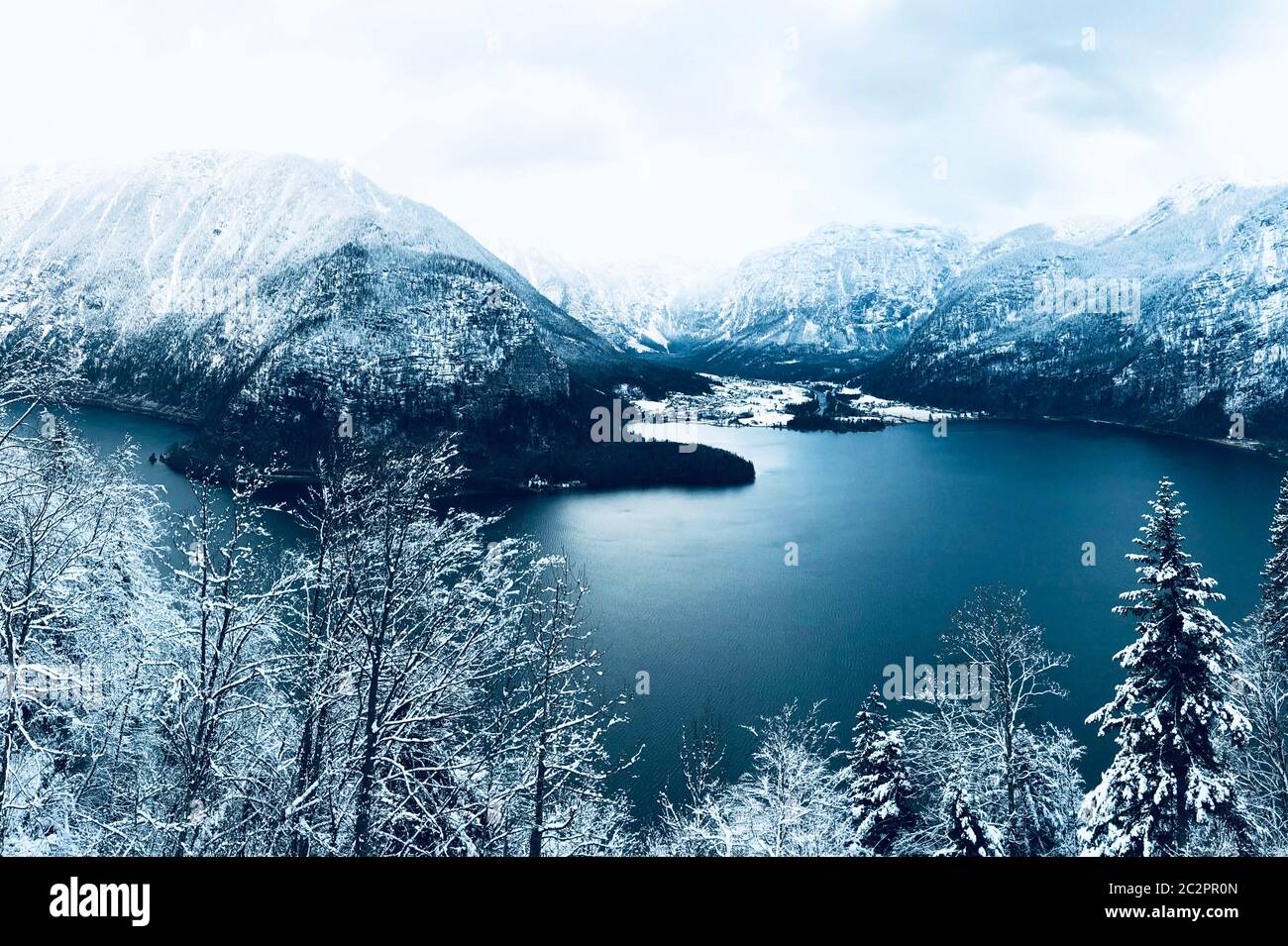 Scenery of Hallstatt Winter snow mountain landscape valley and lake through the forest in upland valley leads to the old salt mine of Hallstatt, Austr Stock Photo