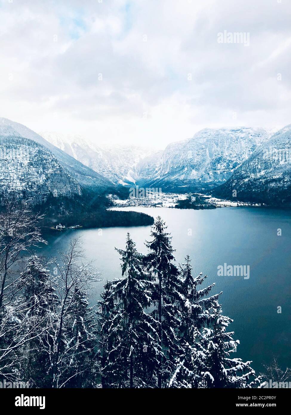 Scenery of Hallstatt Winter snow mountain landscape valley and lake through the forest in upland valley leads to the old salt mine of Hallstatt, Austr Stock Photo